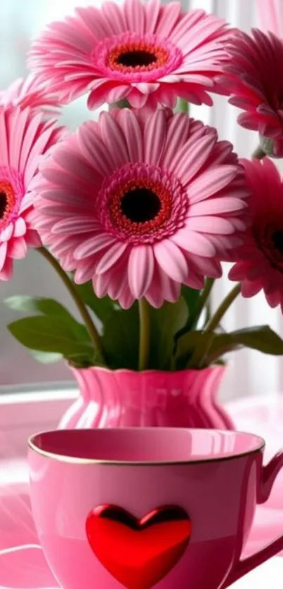 Pink flowers in a heart-themed coffee cup on a window sill.