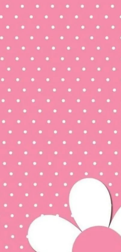 Pink wallpaper with white polka dots and a white flower design.