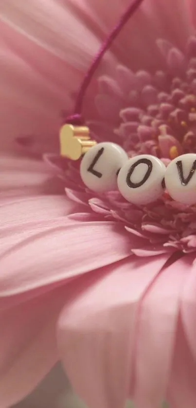 Mobile wallpaper with pink flower and 'Love' beads.