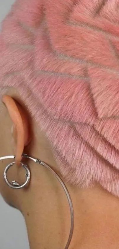 Pink geometric hair design with large hoop earring.