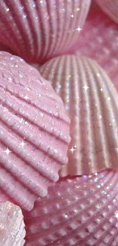 Pink glittery seashells creating a shimmering wallpaper design.