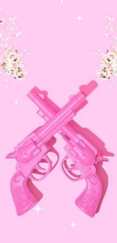 Pink toy guns with glitter accents on vibrant background.