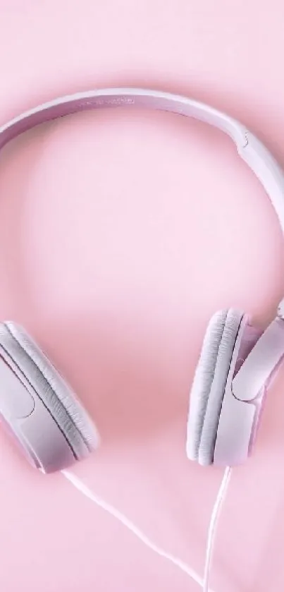 Minimalist pink headphones on a soft pink background.