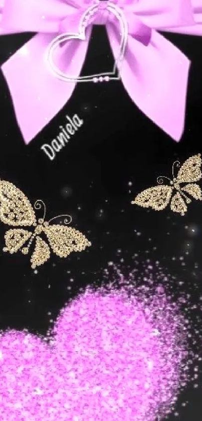 Pink bow, heart, and gold butterflies on black background.