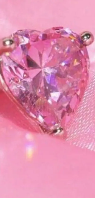 Sparkling pink heart gemstone on silky background.