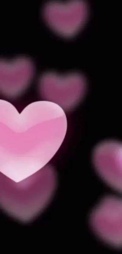 Glowing pink hearts on a dark background, perfect for a romantic mobile wallpaper.