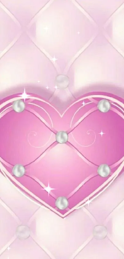 Pink heart with pearl accents on a soft patterned background.