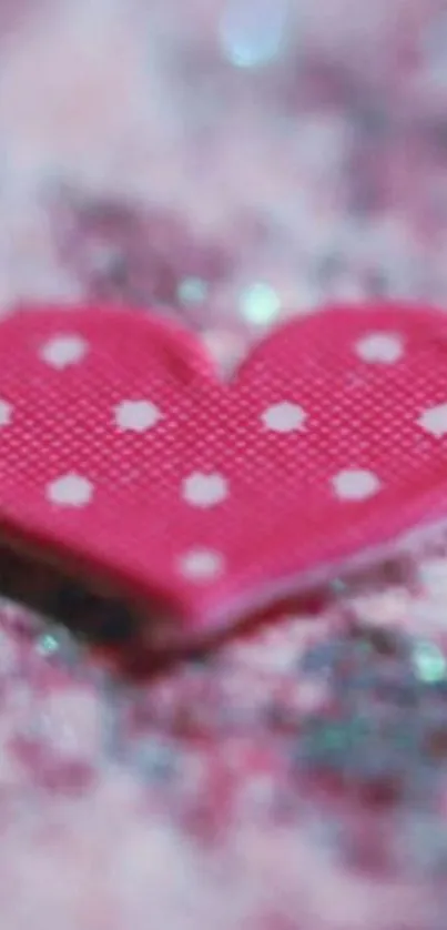 Pink heart with polka dots on pink background.