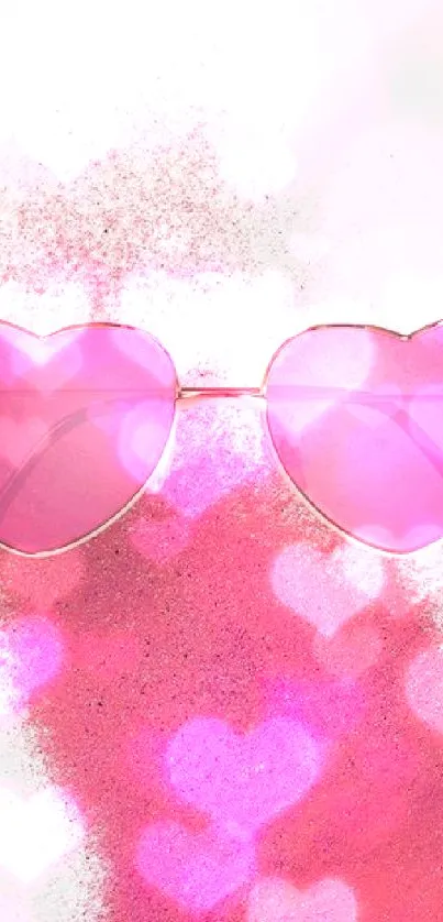 Heart-shaped pink sunglasses with a pink powder background.