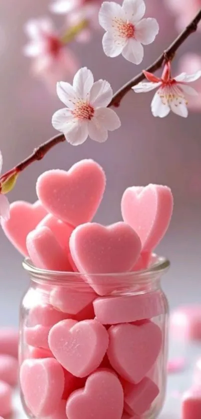 Jar of pink heart-shaped candies with cherry blossoms.