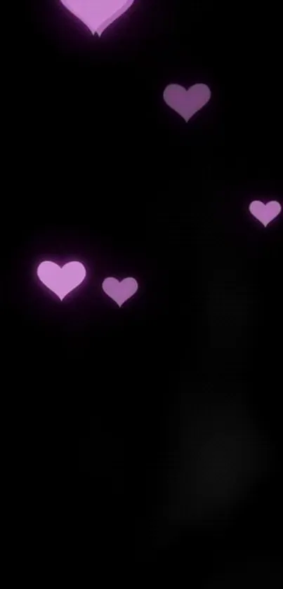 Mobile wallpaper with pink hearts on black background.