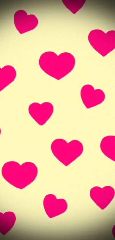 Mobile wallpaper with pink hearts on a yellow background.