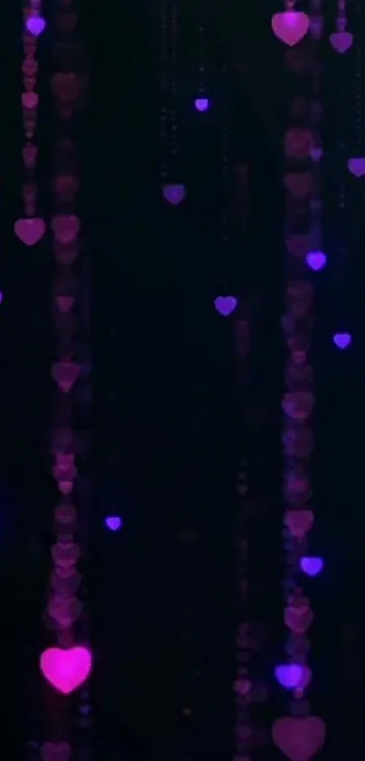 Pink and purple heart lights on a dark wallpaper.