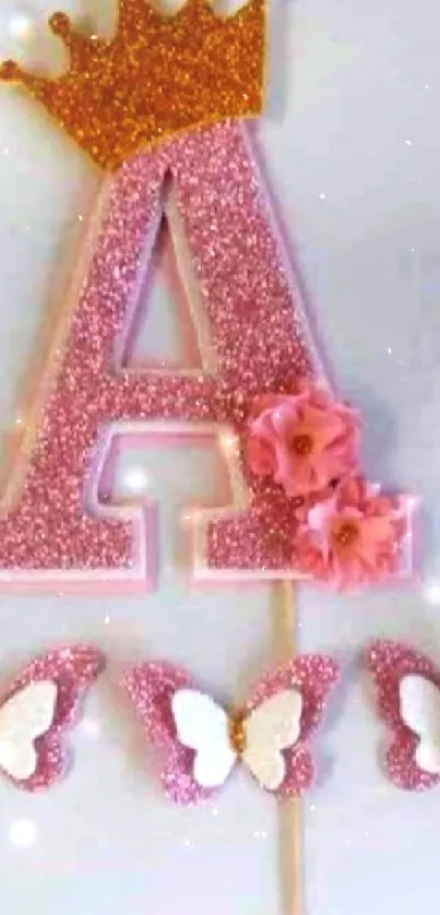 Pink letter A with crown and butterflies on a decorative wallpaper.