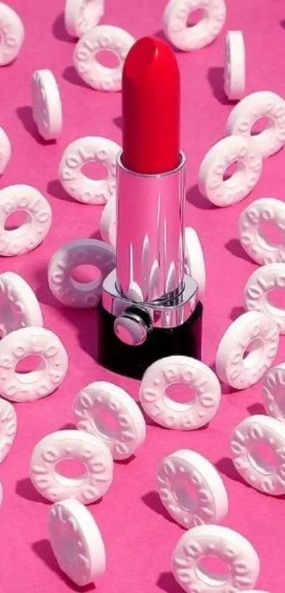 Pink wallpaper with red lipstick and white candy rings.