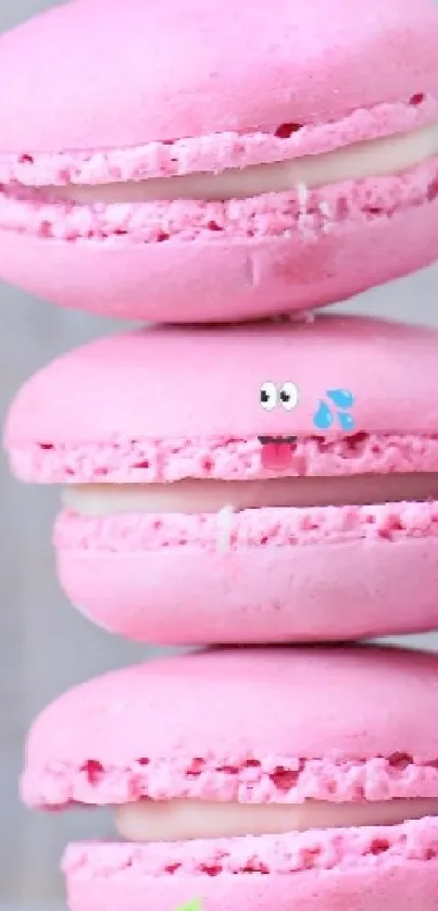 Stack of pink macarons beside a blooming rose in pastel tones.
