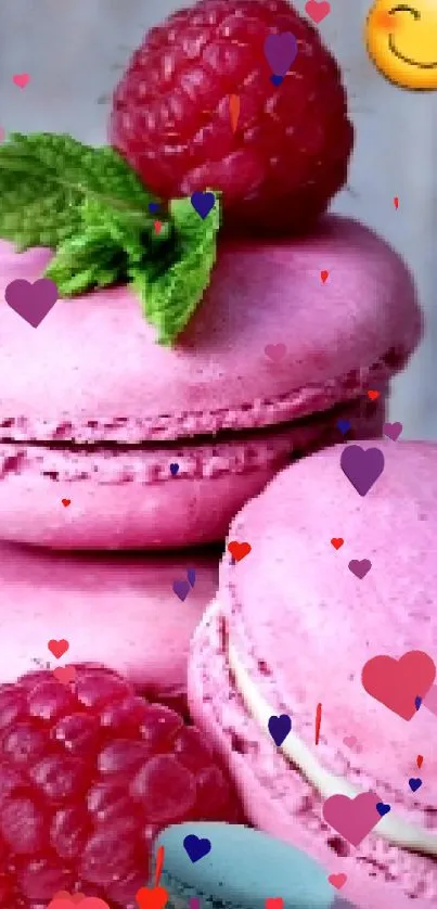 Pink macarons with raspberries and a smiley face.