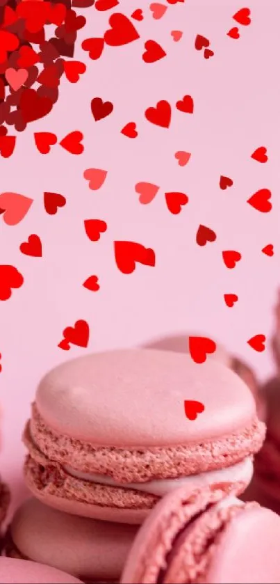 Pink macarons with floating red hearts on a pastel background.