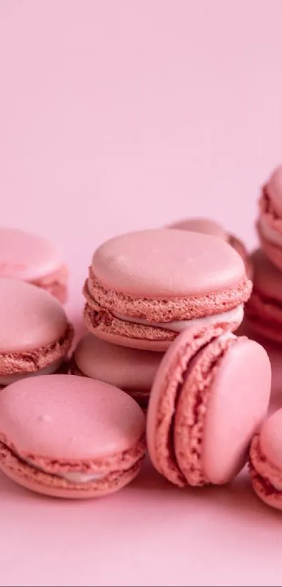 Aesthetic wallpaper of pink macarons stacked creatively.