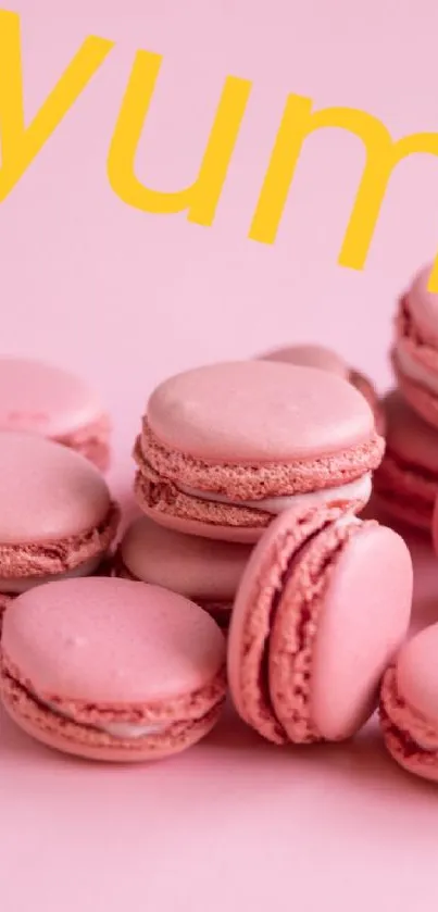 Pink macarons with 'yum' text on a vibrant background.