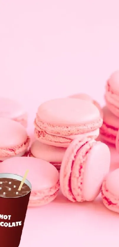 Pastel pink macarons stacked with a cup of hot chocolate.
