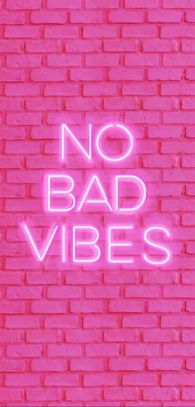 No Bad Vibes neon sign on pink brick wall.
