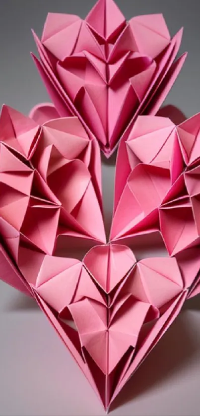 Intricate pink origami heart design on paper background.