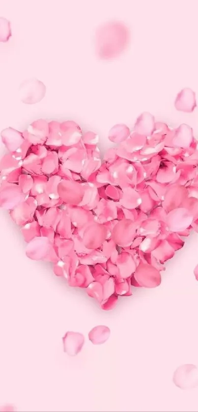 Heart made of pink petals on a soft background.