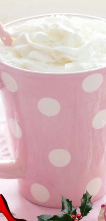 Pink polka dot mug with whipped cream topping on a mobile wallpaper.