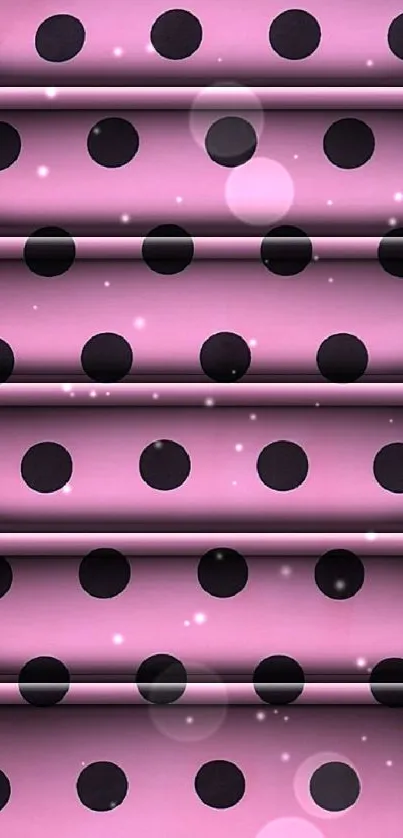 Pink wallpaper with bold black polka dots creating a stylish pattern.