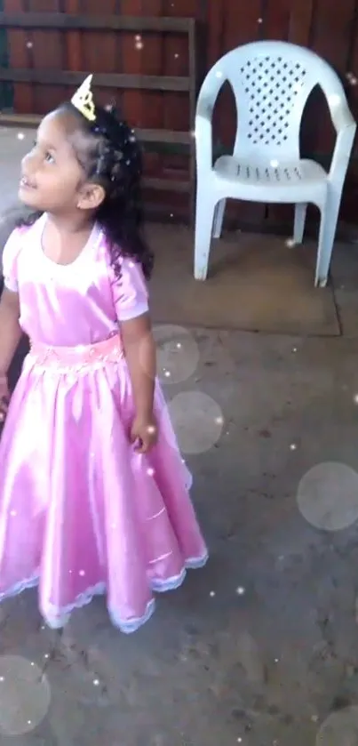 Young girl in pink princess dress with bokeh effect.