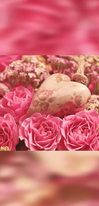 Beautiful pink roses with a vintage heart ornament in a floral arrangement.