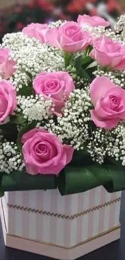 Bouquet of pink roses in a decorative box.