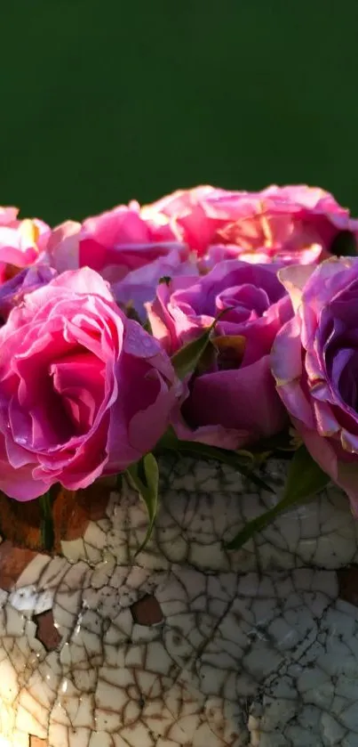 Elegant arrangement of pink roses in a rustic ceramic vase against green background.