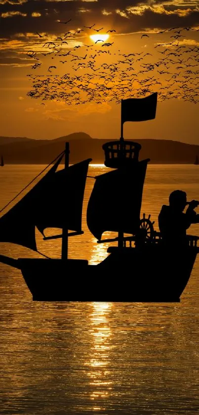 Pirate ship silhouette against a vibrant orange sunset on calm waters.