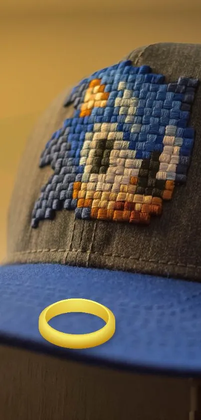 Pixel art design on a blue cap with a yellow ring.