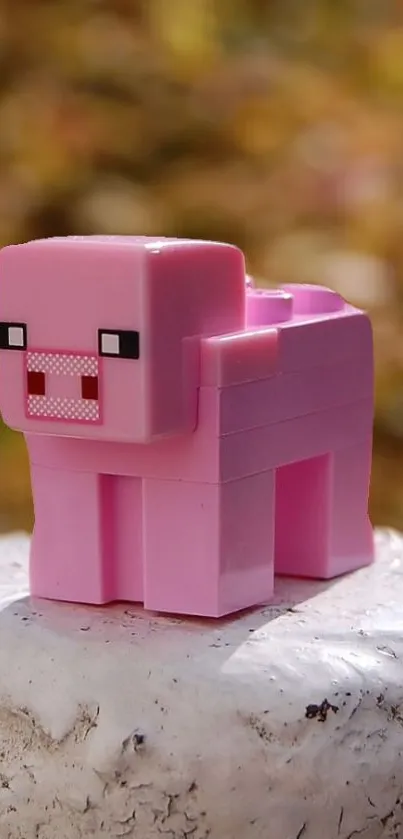 Pixelated pink pig block on a textured surface.