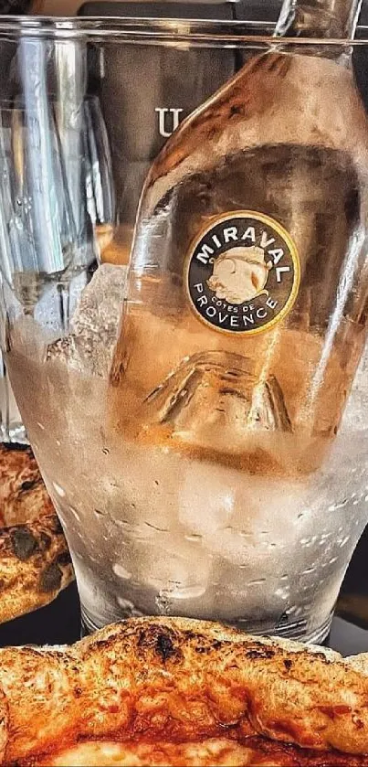 Bottle of wine in ice surrounded by pizzas