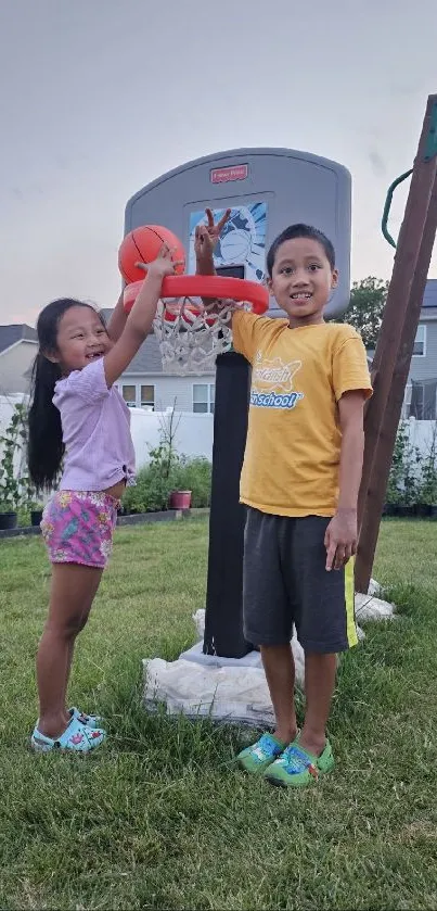 Children playing basketball in the backyard on a sunny day.