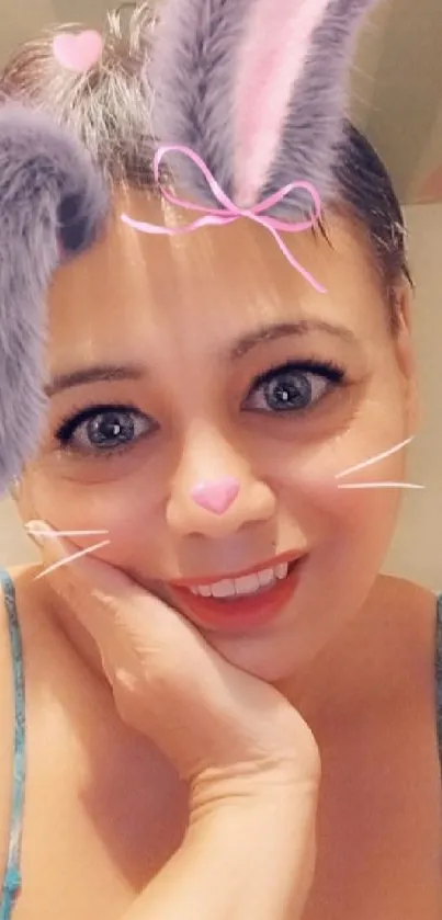 Woman with bunny ears filter and smiling expression.