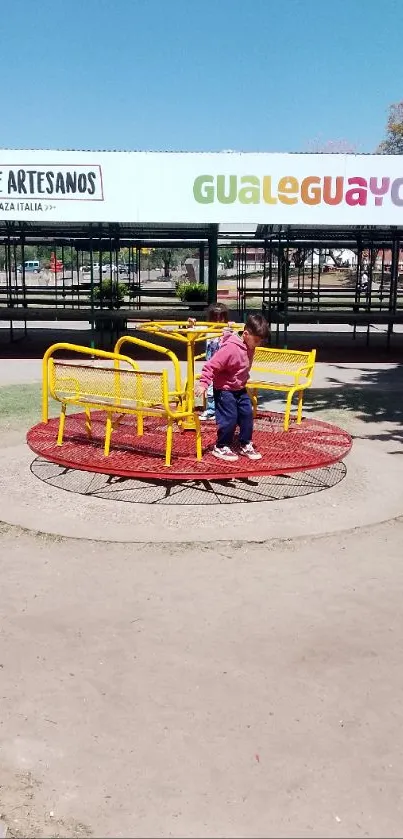 Children playing on vibrant playground equipment under a clear blue sky.