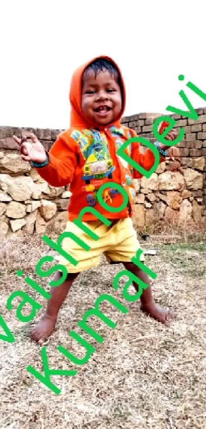 Smiling child in orange hoodie playing outdoors. Bright and cheerful setting.