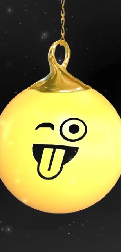 A playful yellow emoji ornament winking face on a black background.