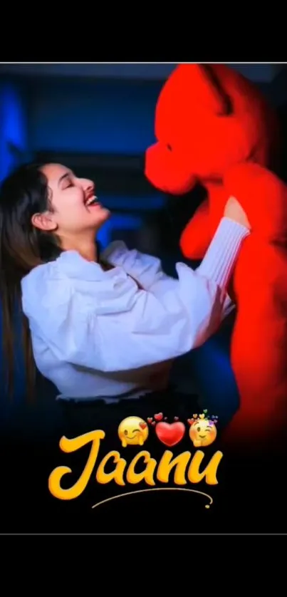 A young woman joyfully hugs a large red teddy bear.