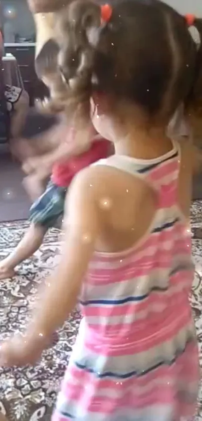 Children dancing indoors with sparkles around.