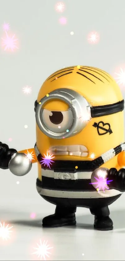 Minion toy in overalls holding weights on a light background.