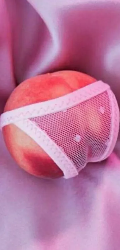 Playful artwork of a peach in lingerie on pink satin.