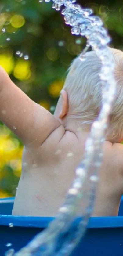 Child splashing water in blue bucket outdoors.