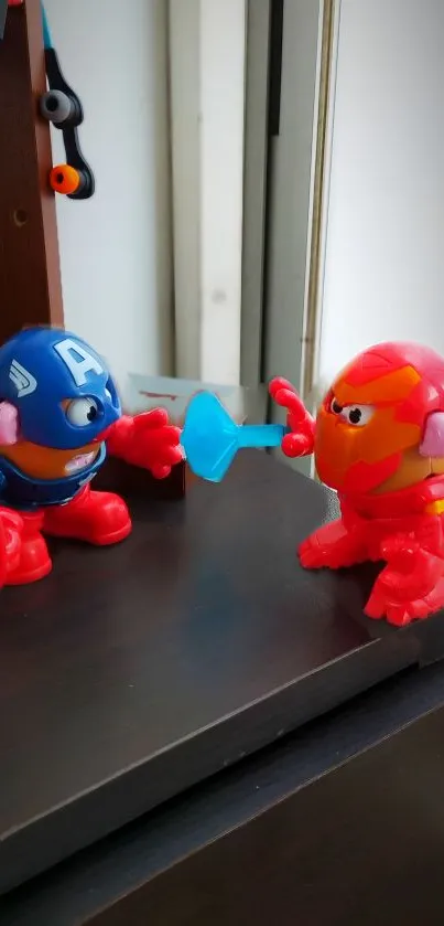 Two toy figures resembling superheroes in a playful battle scene.