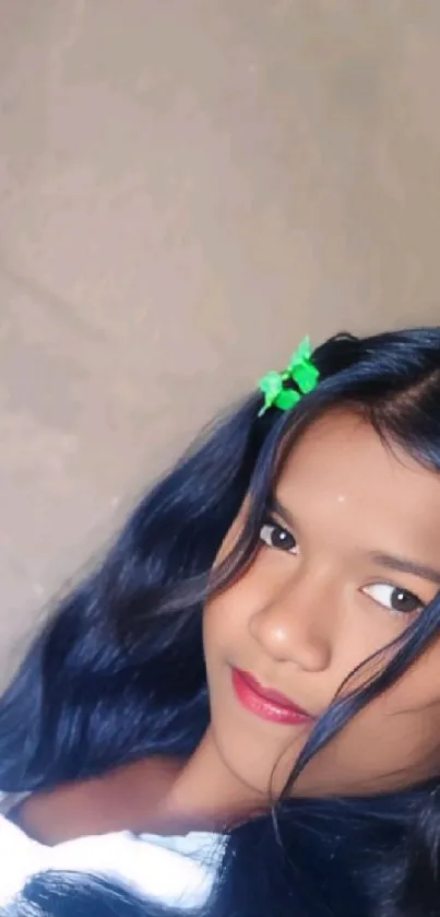 Portrait of a young girl with vibrant hair and colorful clip.